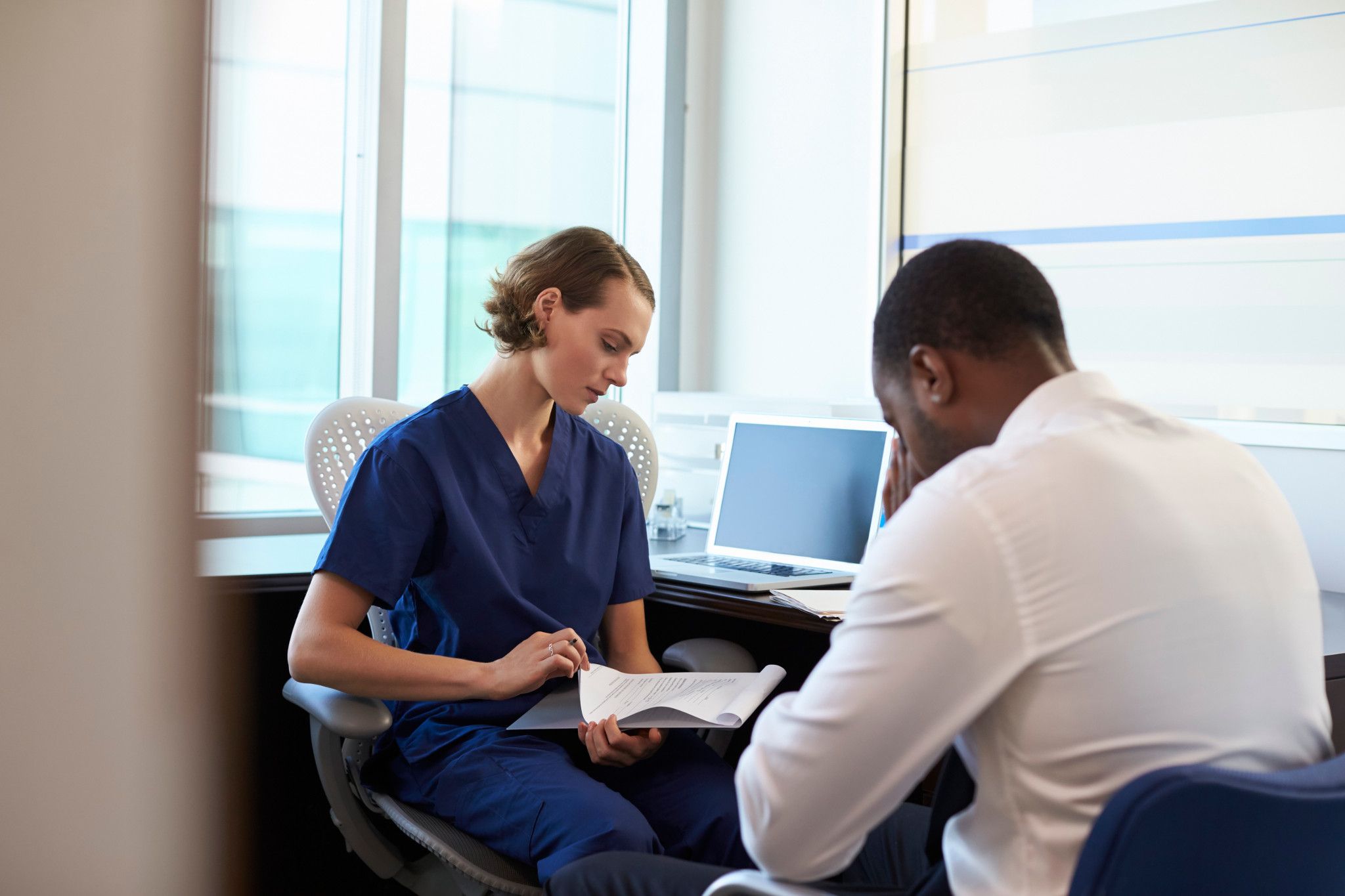 health care professional reviewing records with patient