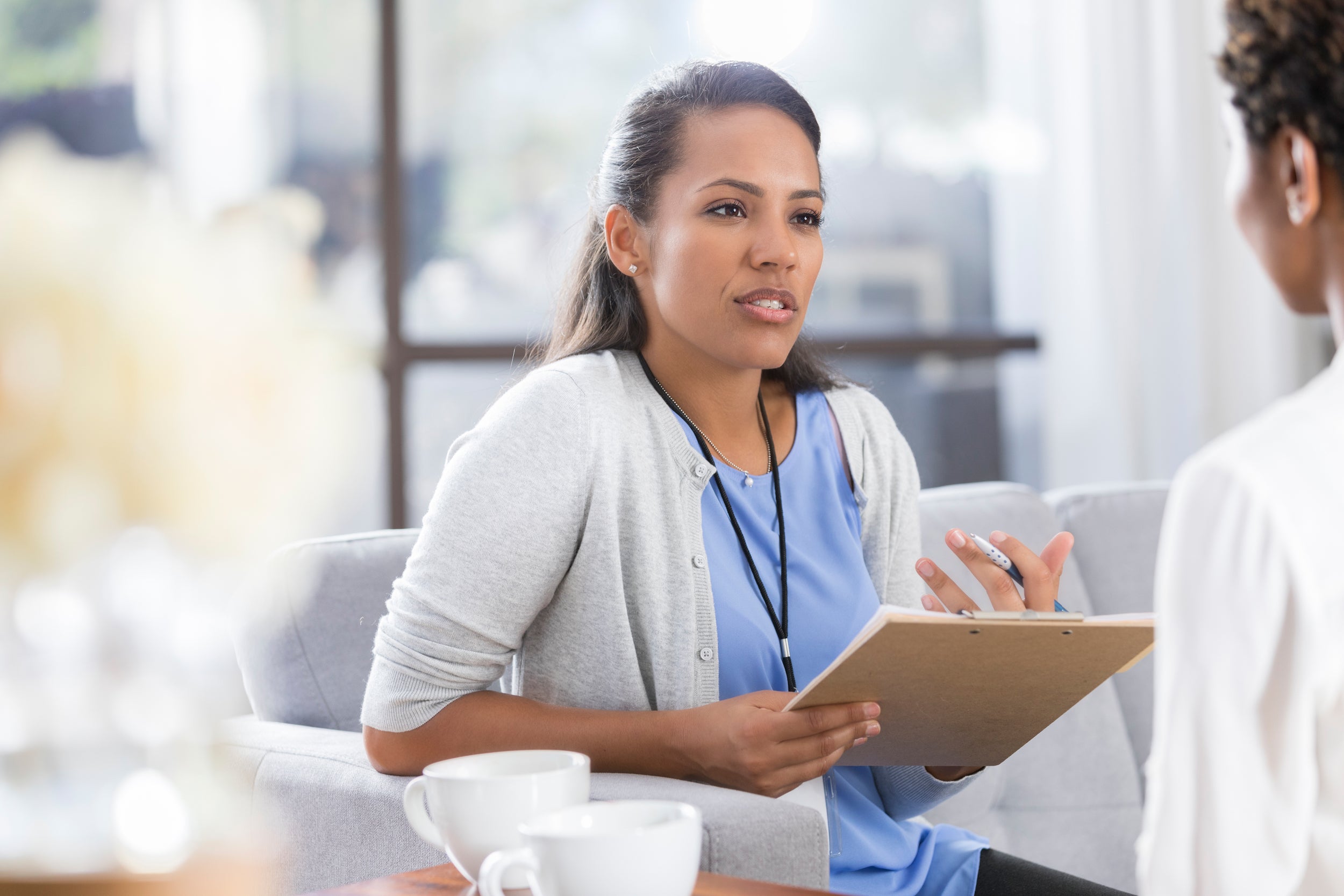 female psychiatrist discusses something with female patient
