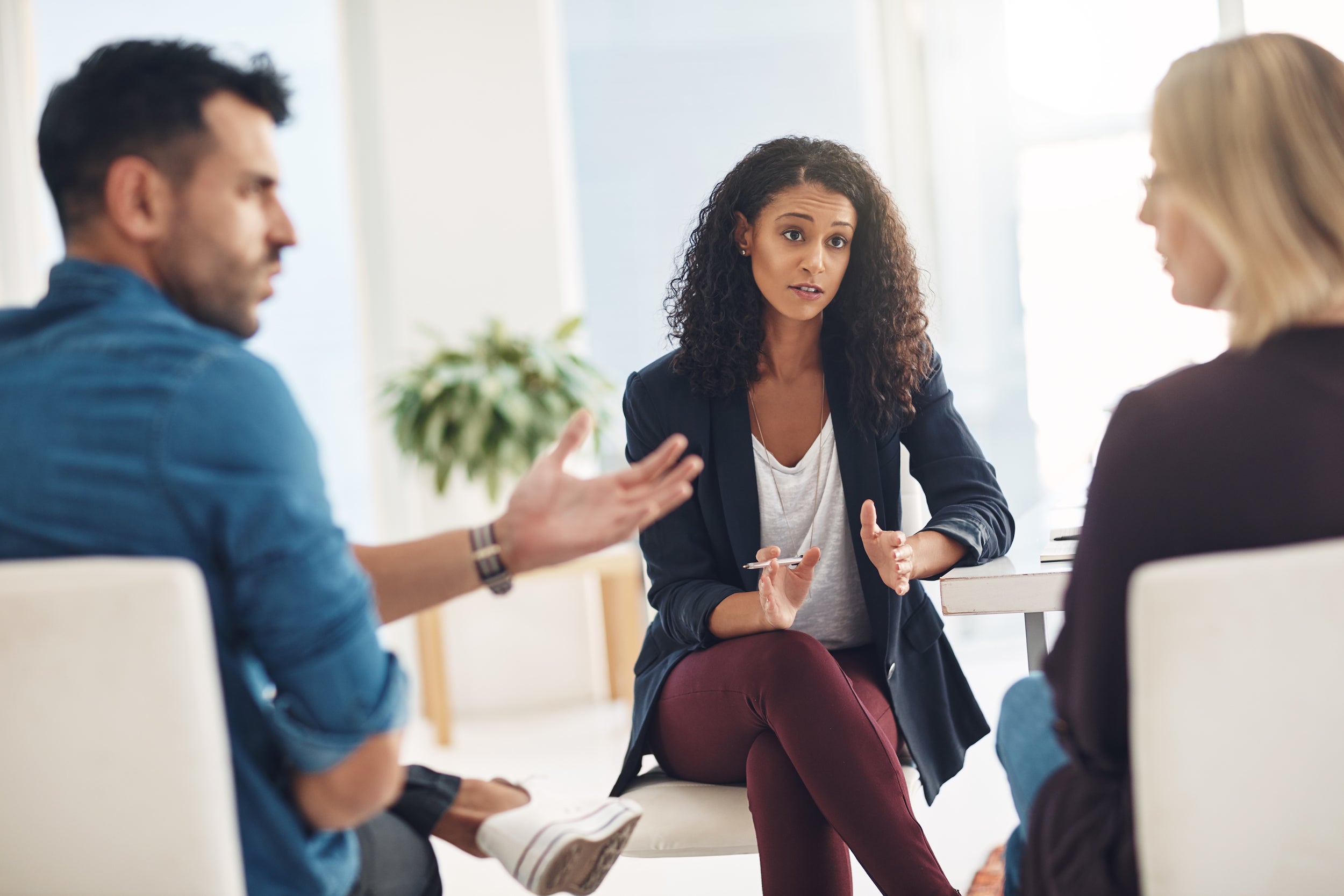 woman therapist talking with couple