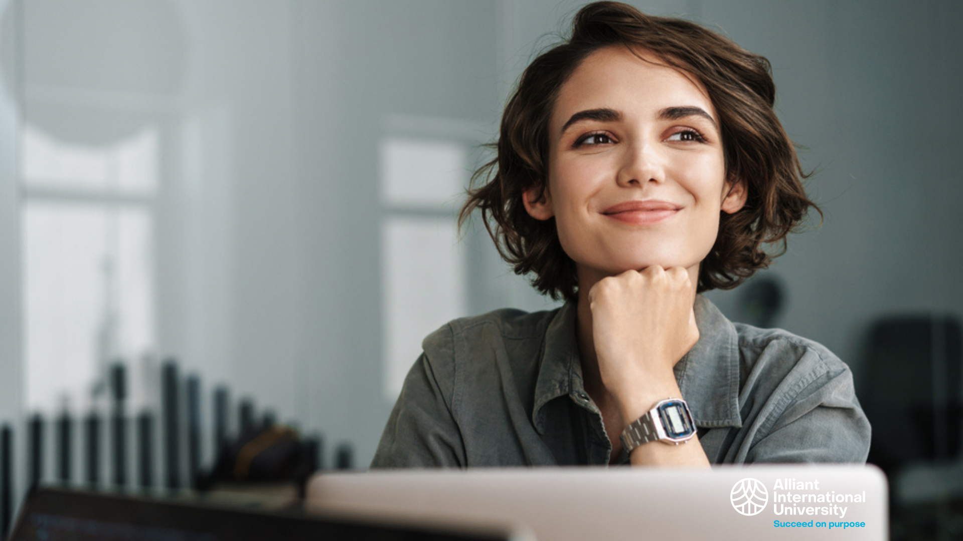 Woman thinking while in front of laptop