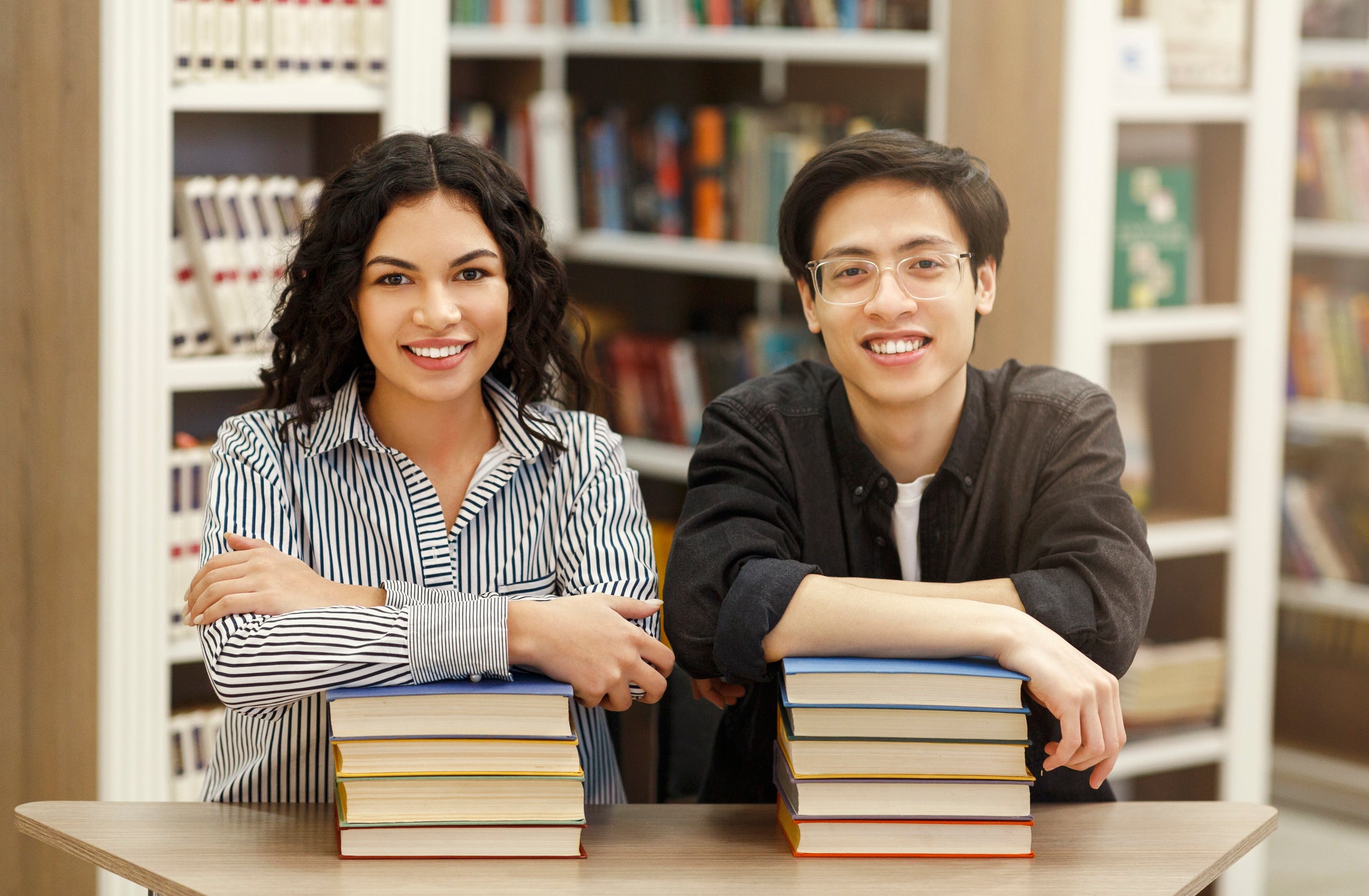 two students holding books