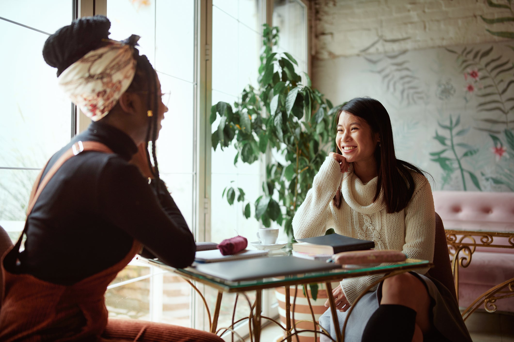 two female students chatting at table