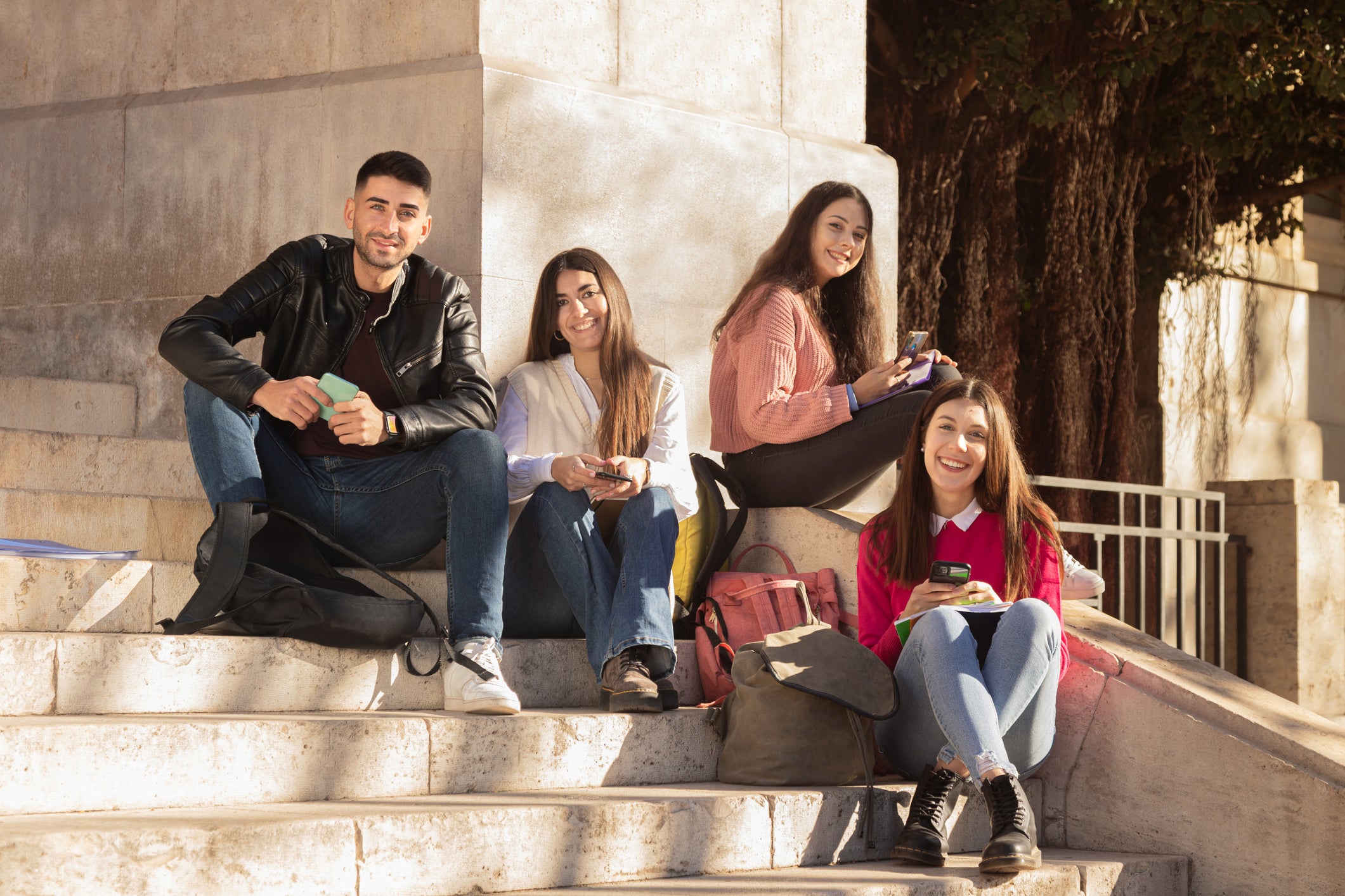 students sitting on stairs studying