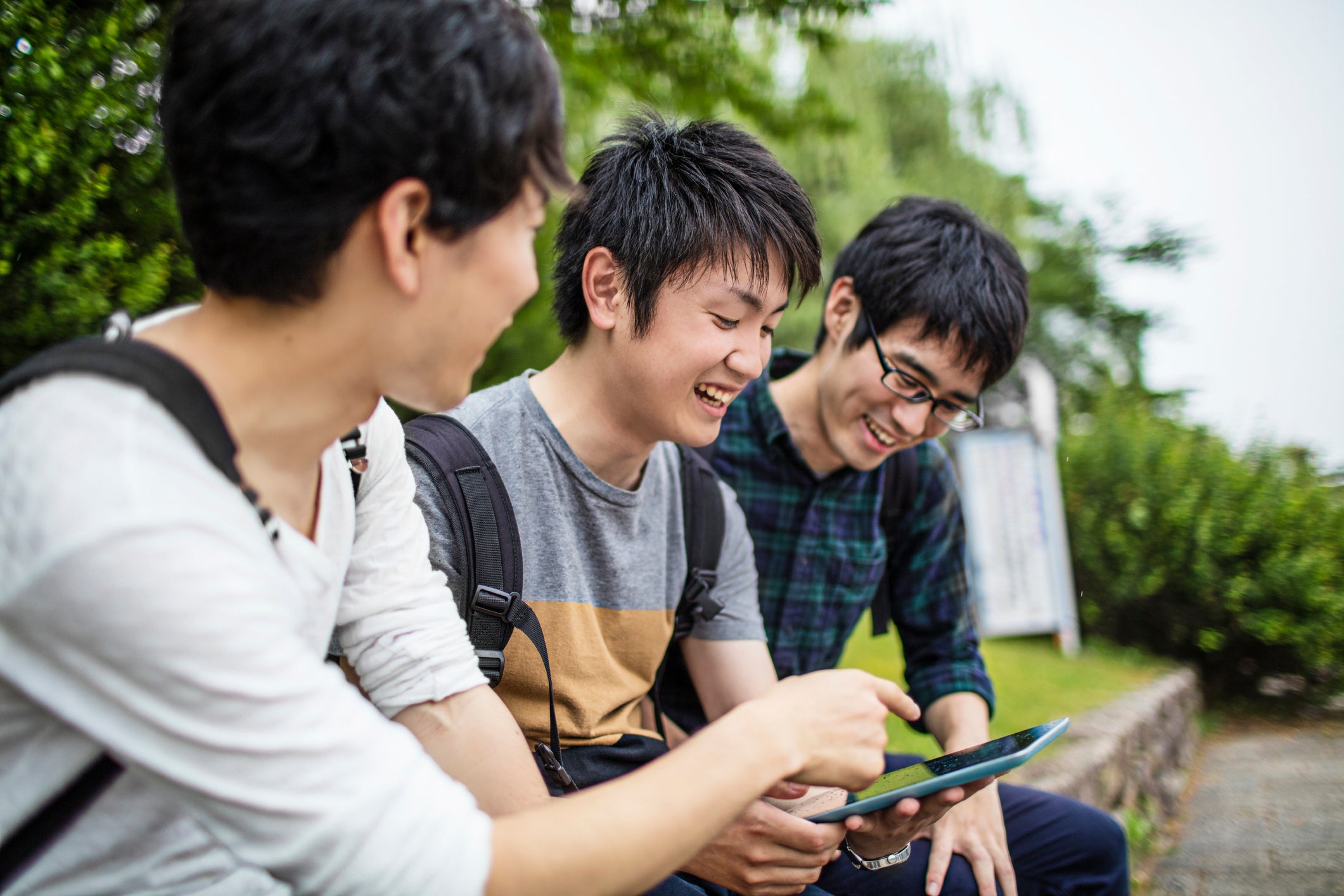 students sitting on ledge chatting