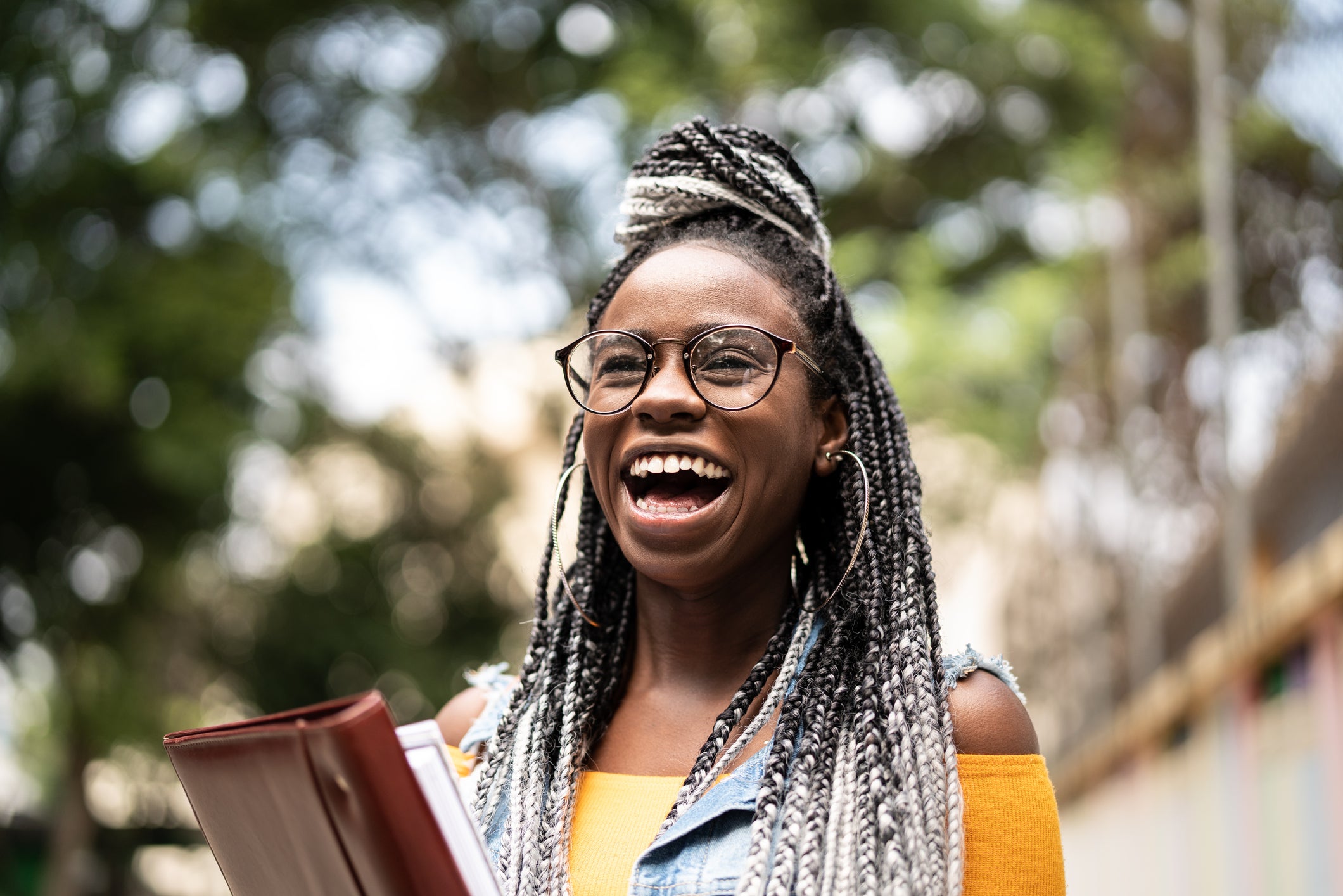 Smiling student holding folder