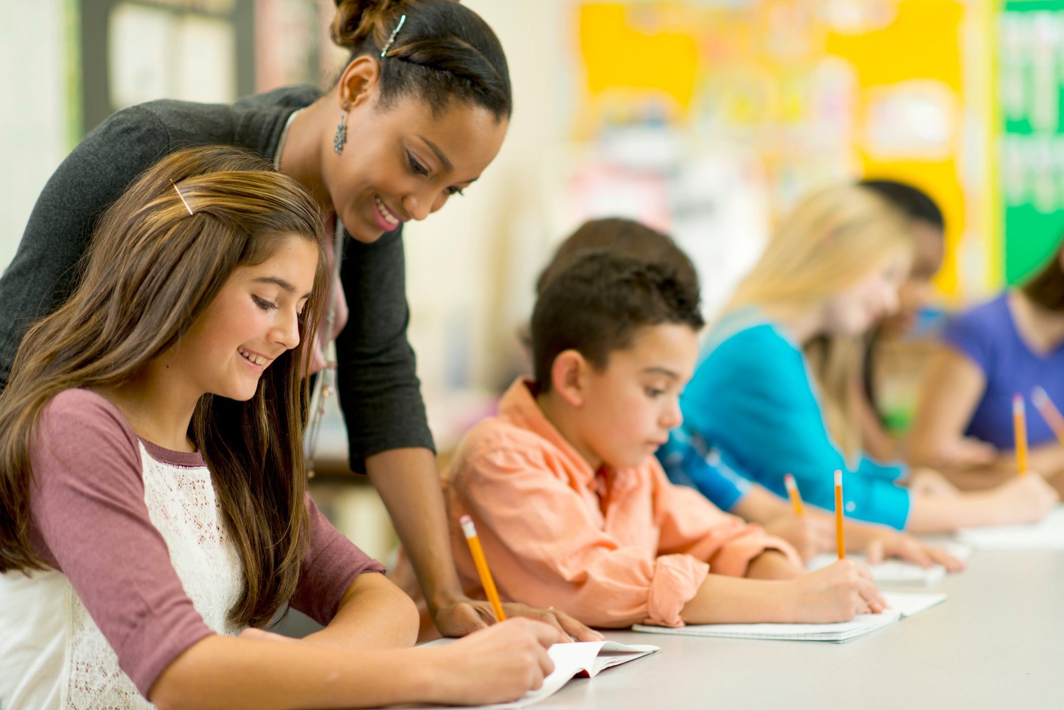 teacher helping middle school students