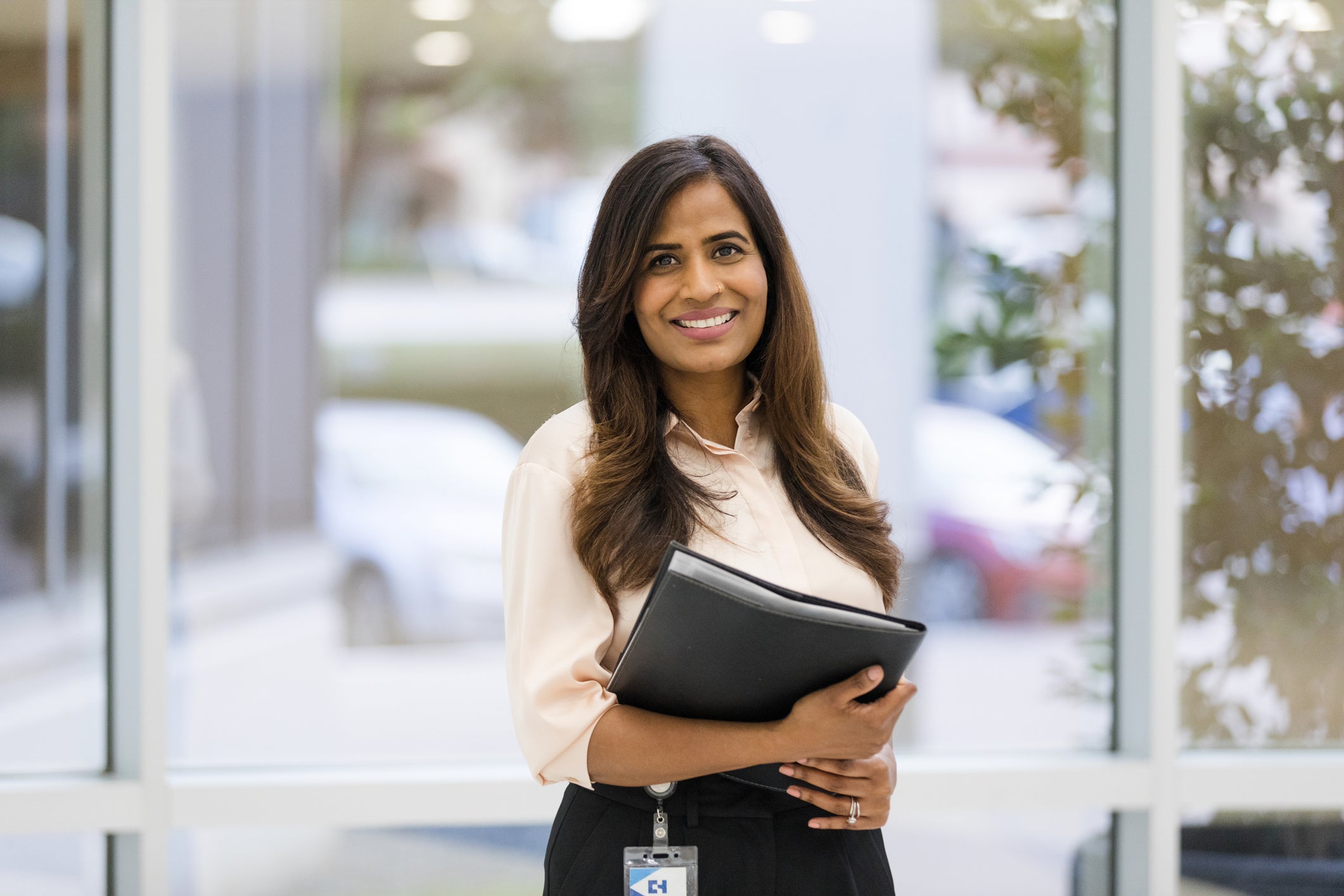 therapist holding folder looking at camera