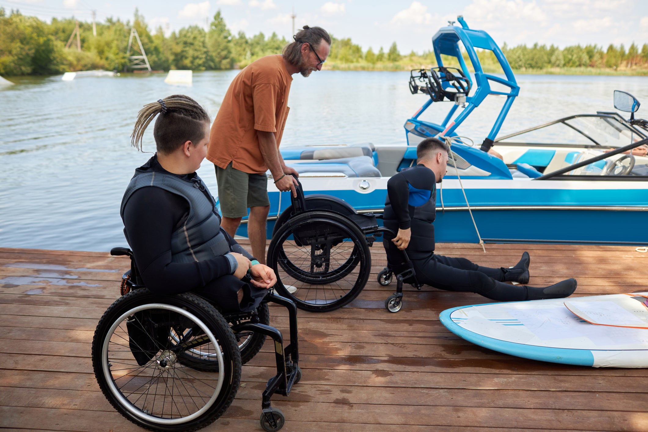 therapist helping man on wheelchair