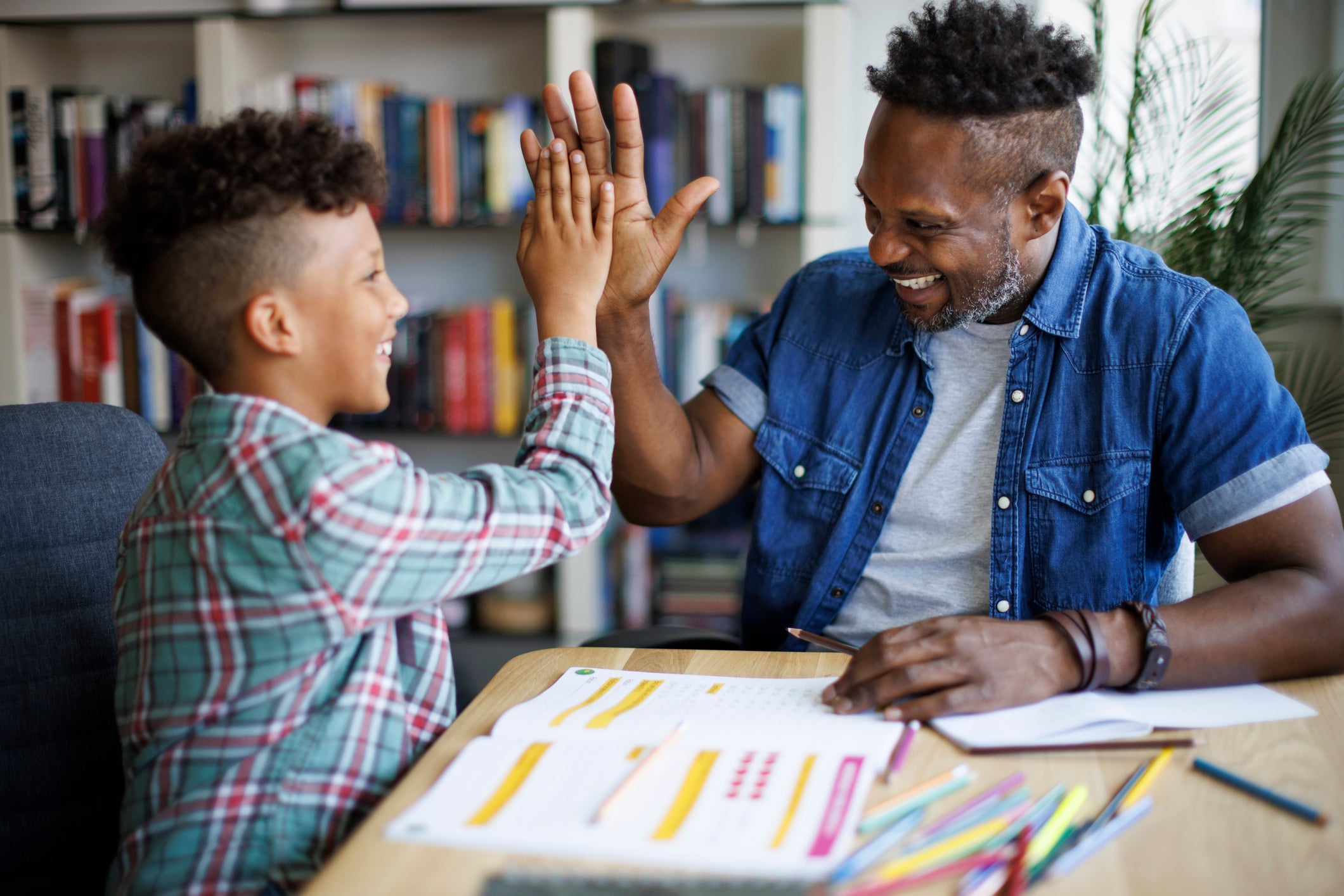 teacher high fiving student