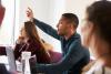 student raising hand in class