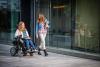 woman in wheelchair strolls with another woman