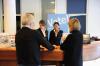 hospitality management students greet guests at front desk