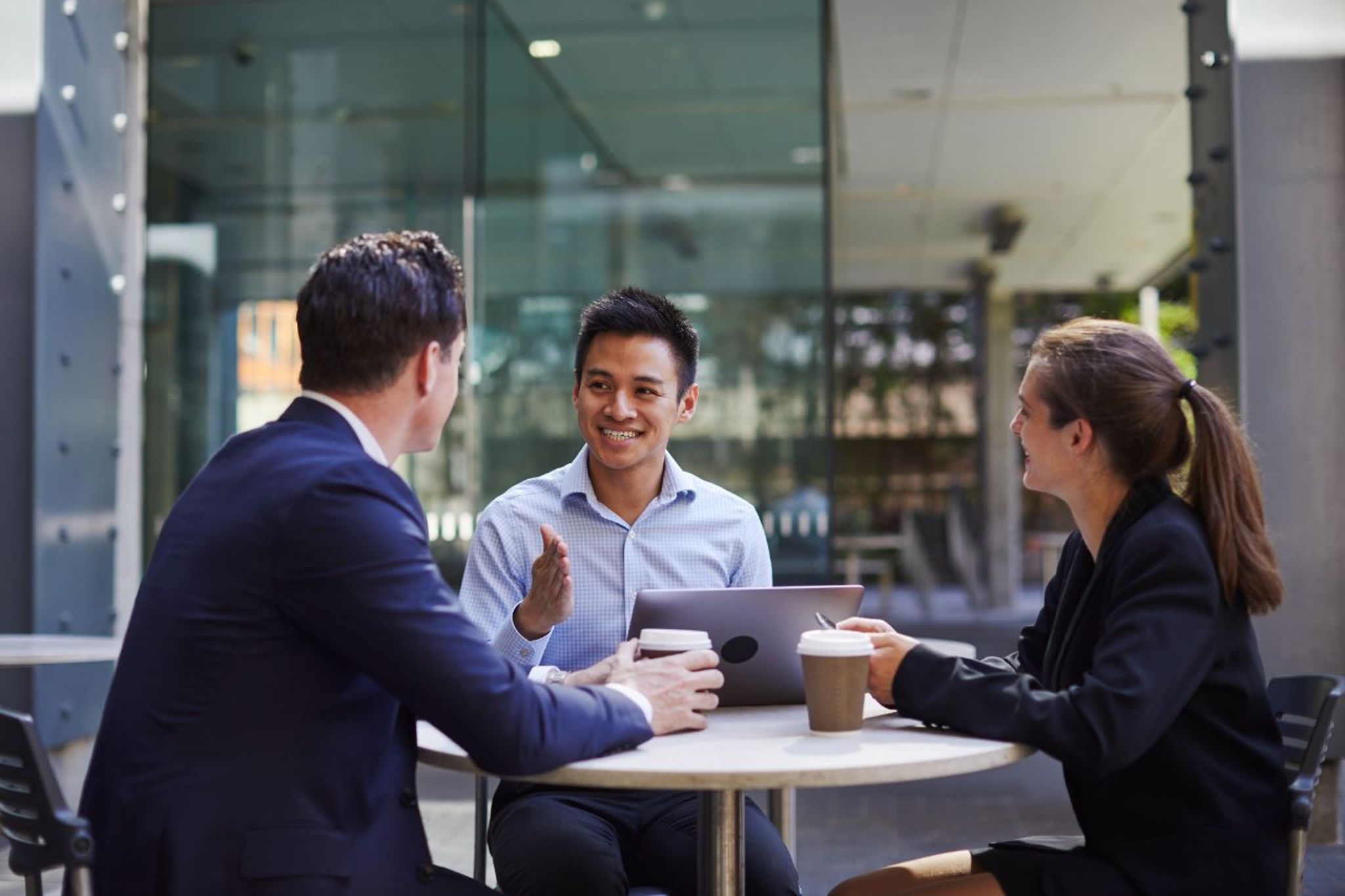students from a graduate program in business talking at a cafe