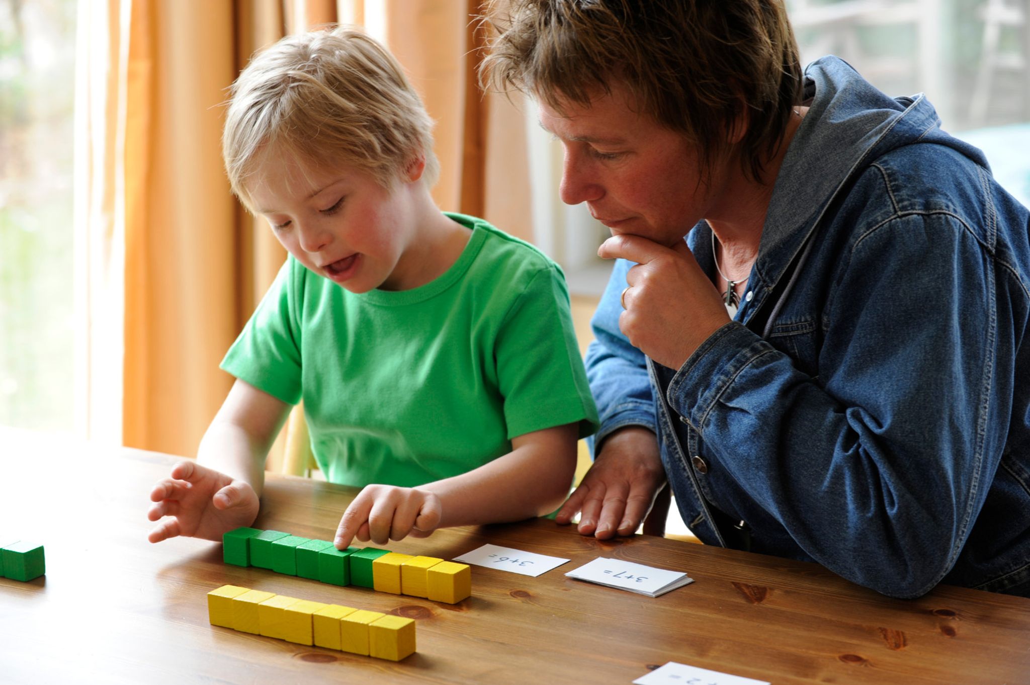 teacher observing student playing with blocks