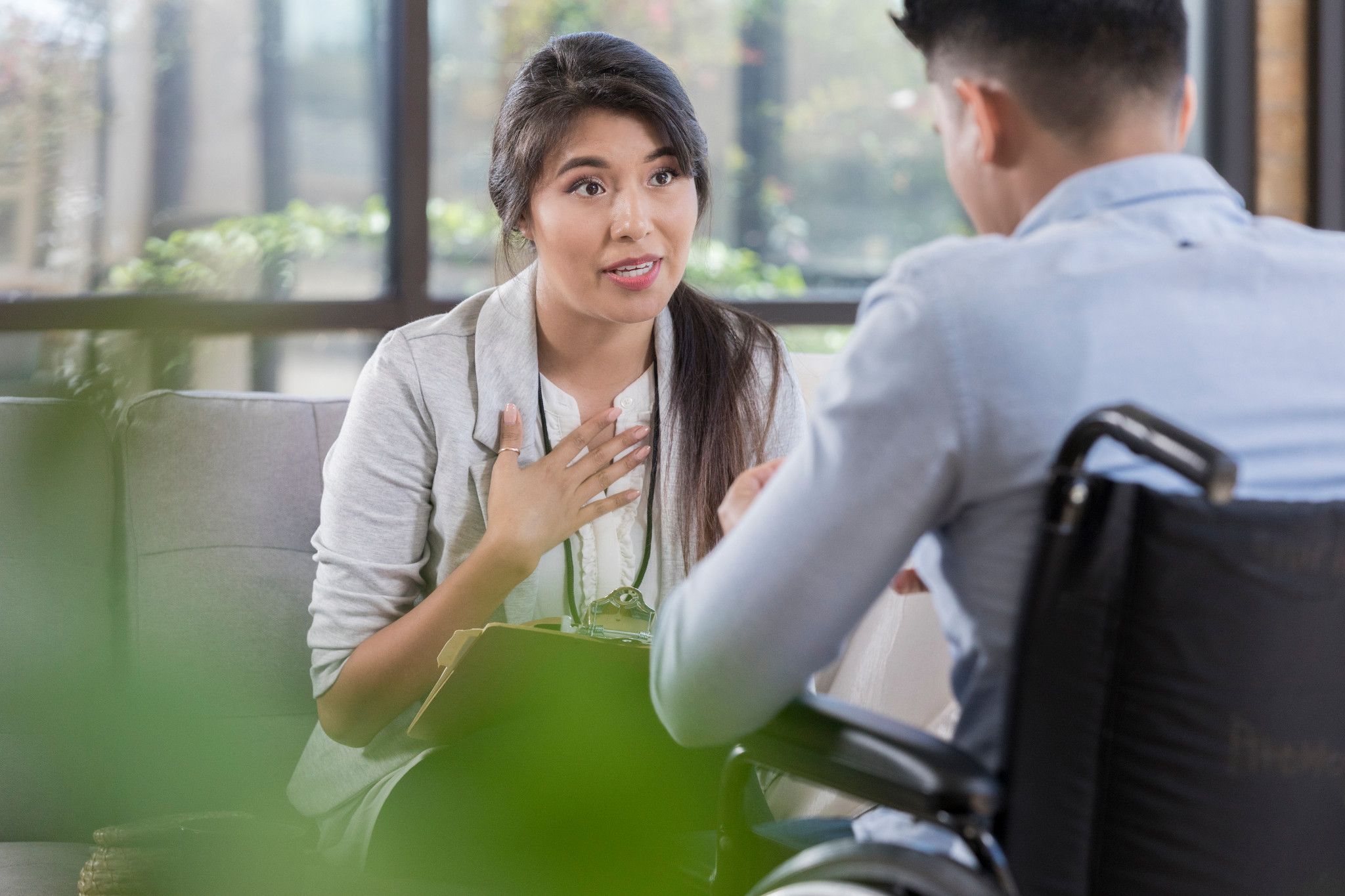 doctor with Fresno masters programs credential talking to patient in wheelchair