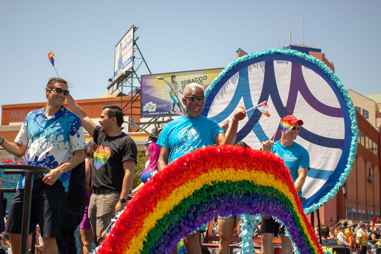 people on alliant float at pride parade