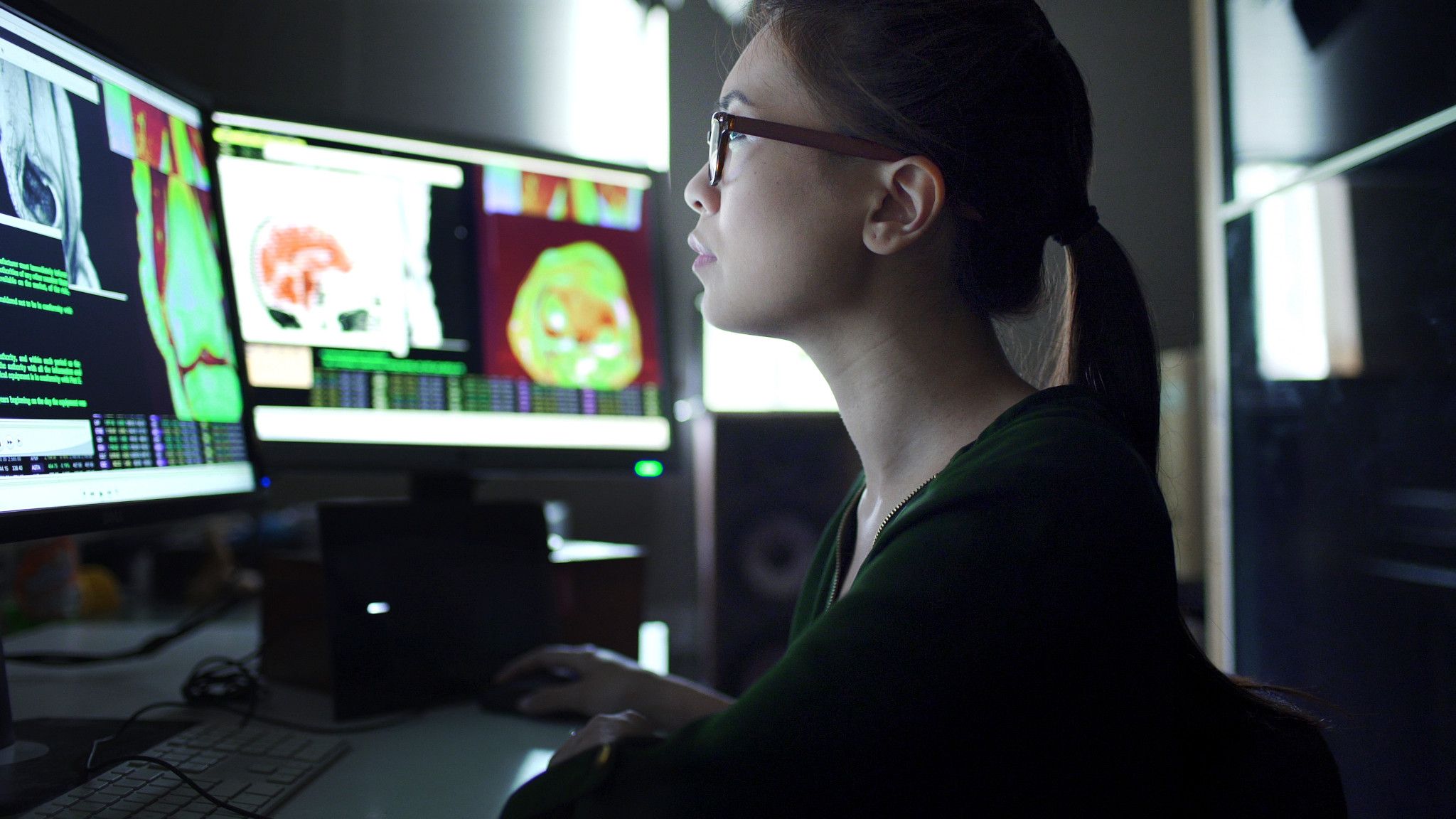 woman reviewing bio data on computers
