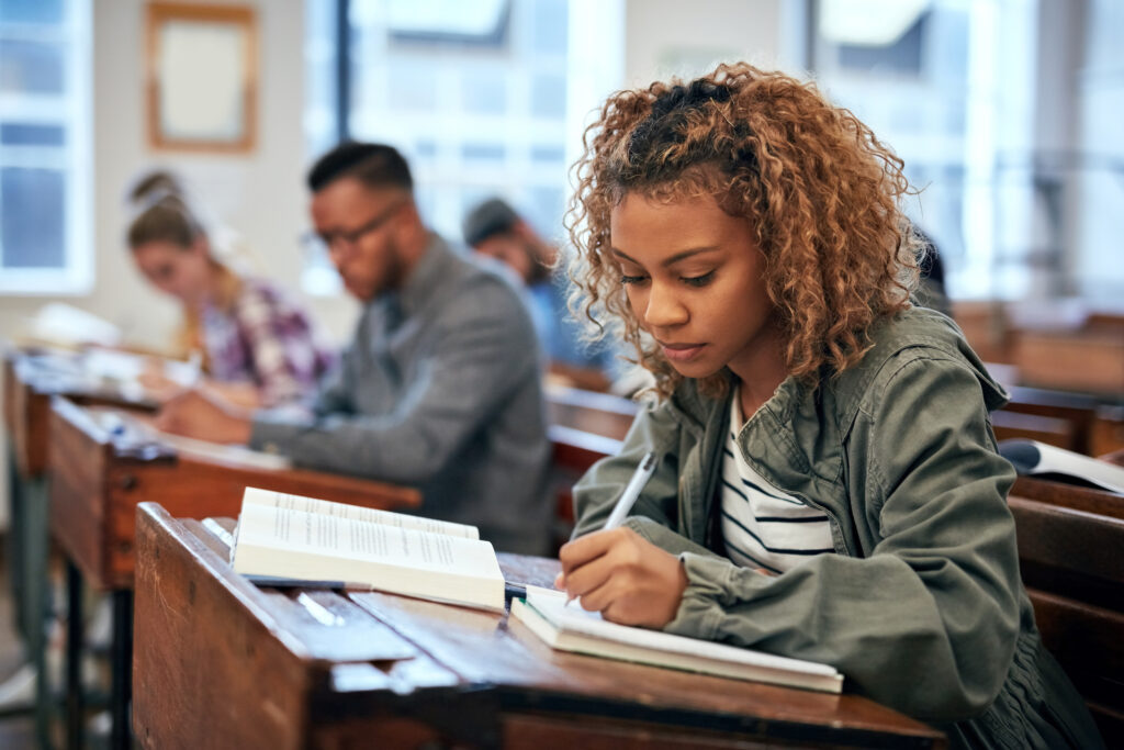 female student taking notes