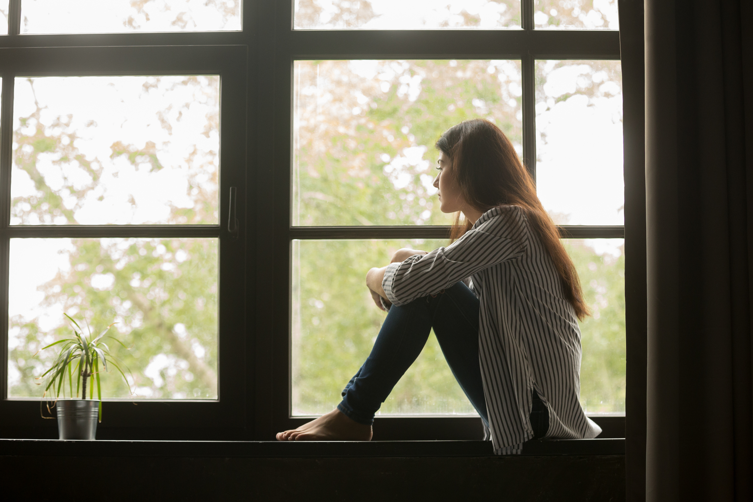 woman sitting staring out window