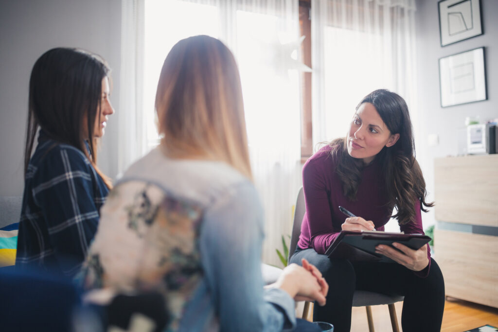 woman counselor talking to two women