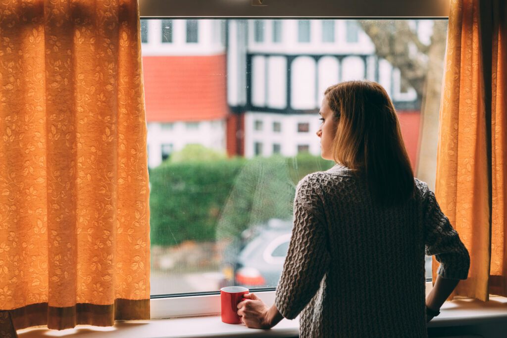 woman staring out window