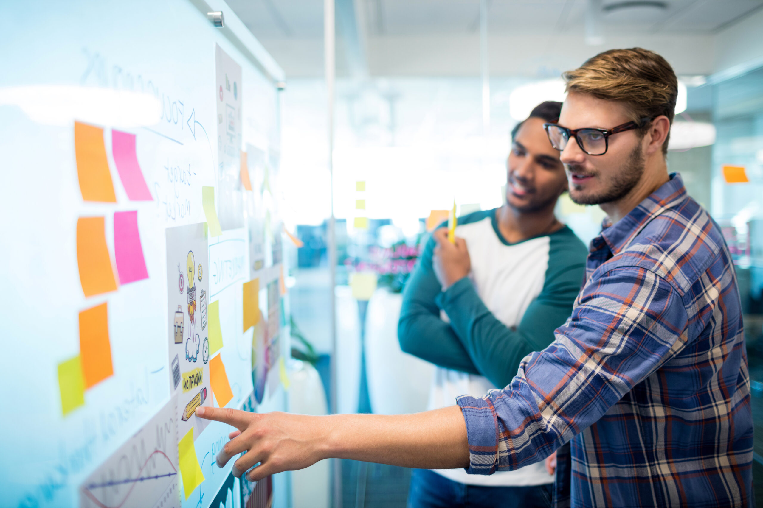 creative business team reading the sticky notes and discussing