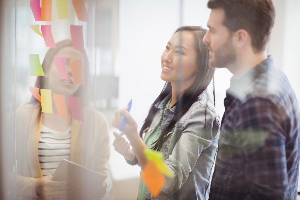 students writing at board