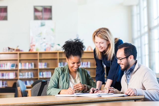 Adult students studying in library