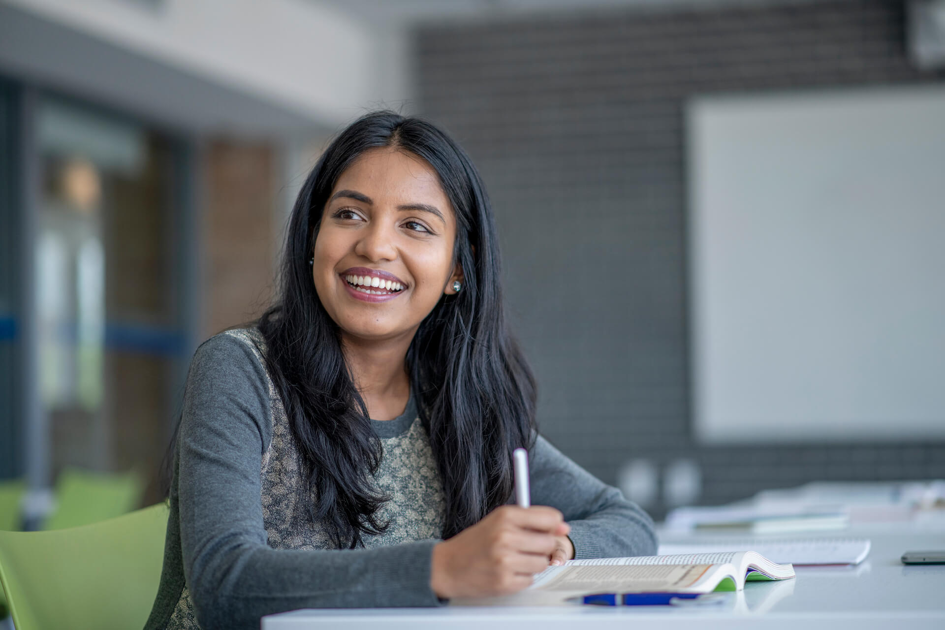 smiling student with notebook