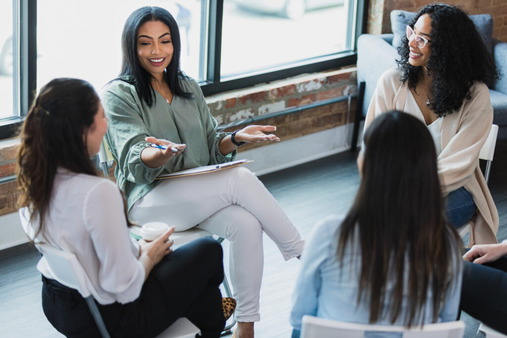 woman leading a group meeting in circle