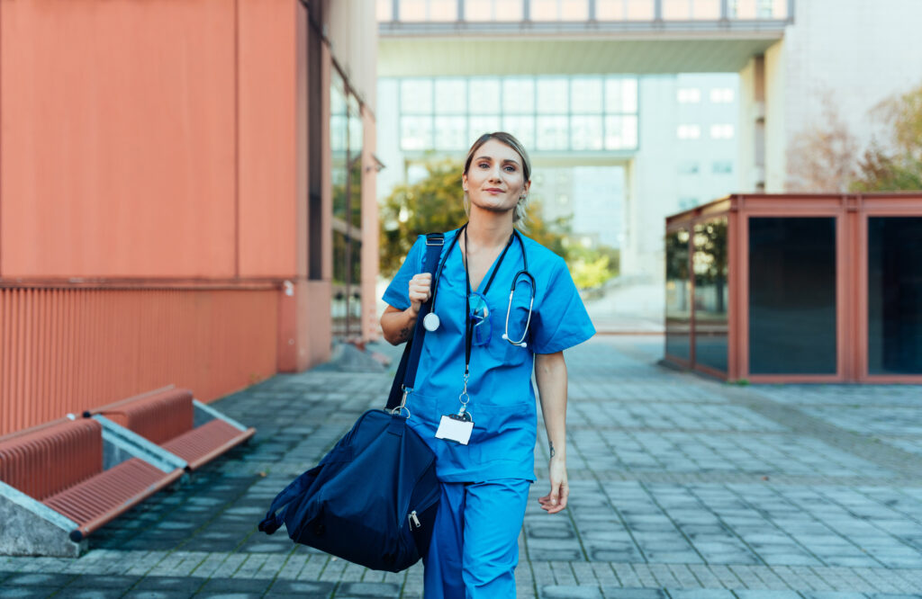 Nurse walking with a shoulder bag