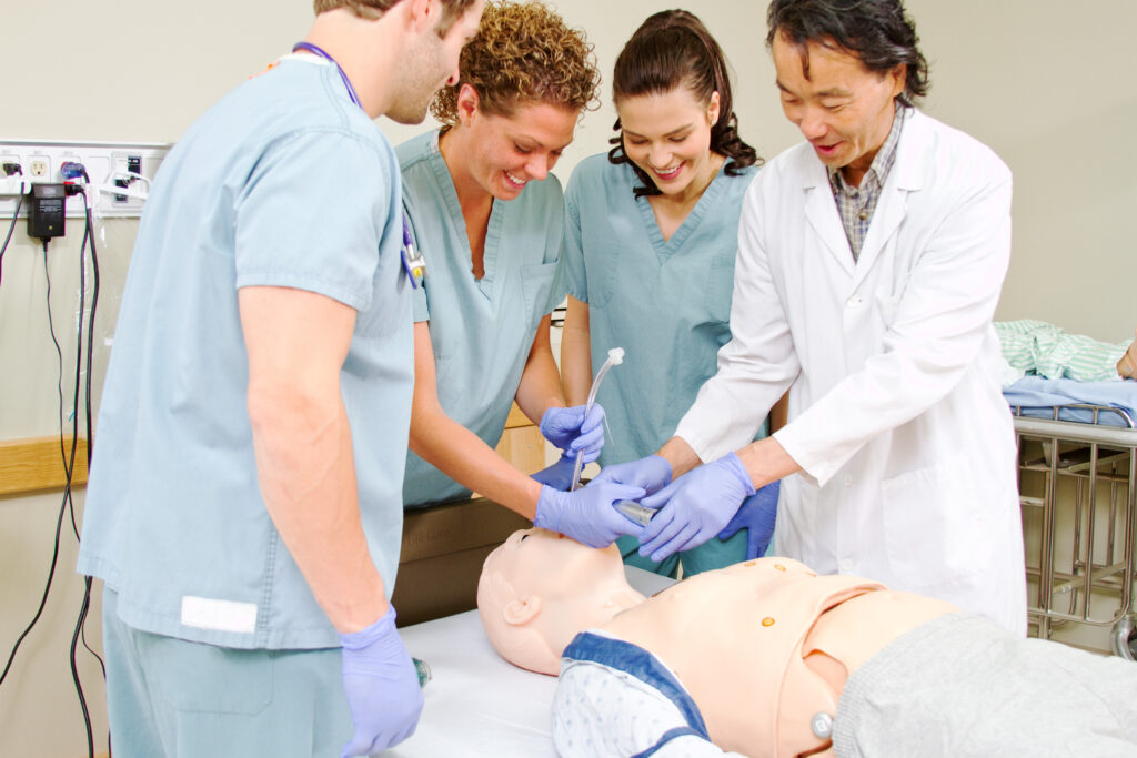 Nurses practicing on dummy