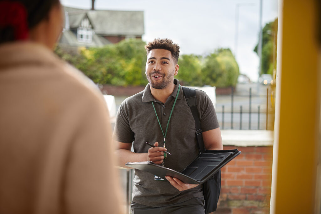 man talking while taking notes
