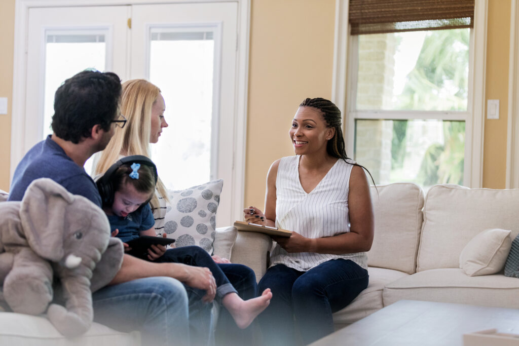 woman holding clipboard talking to family