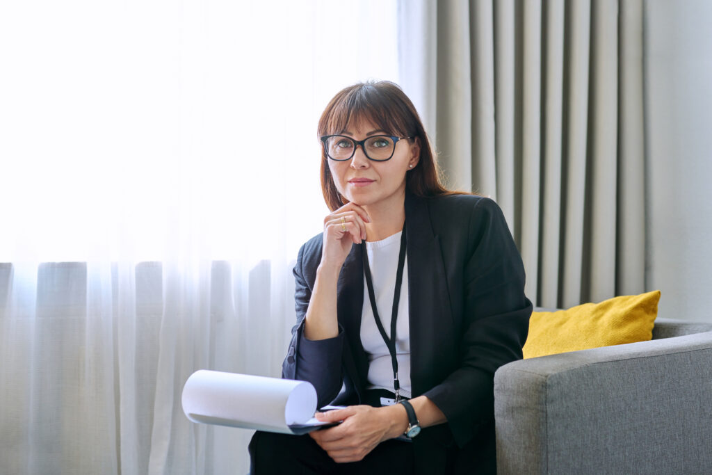 woman holding clipboard looking at camera