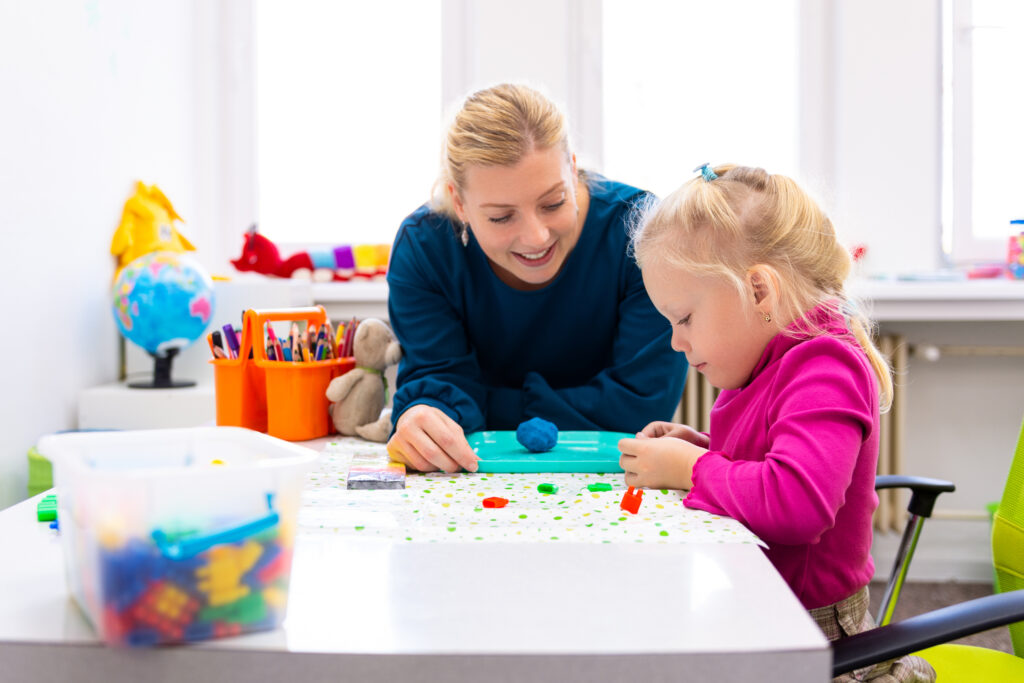 occupational therapist helping a young girl
