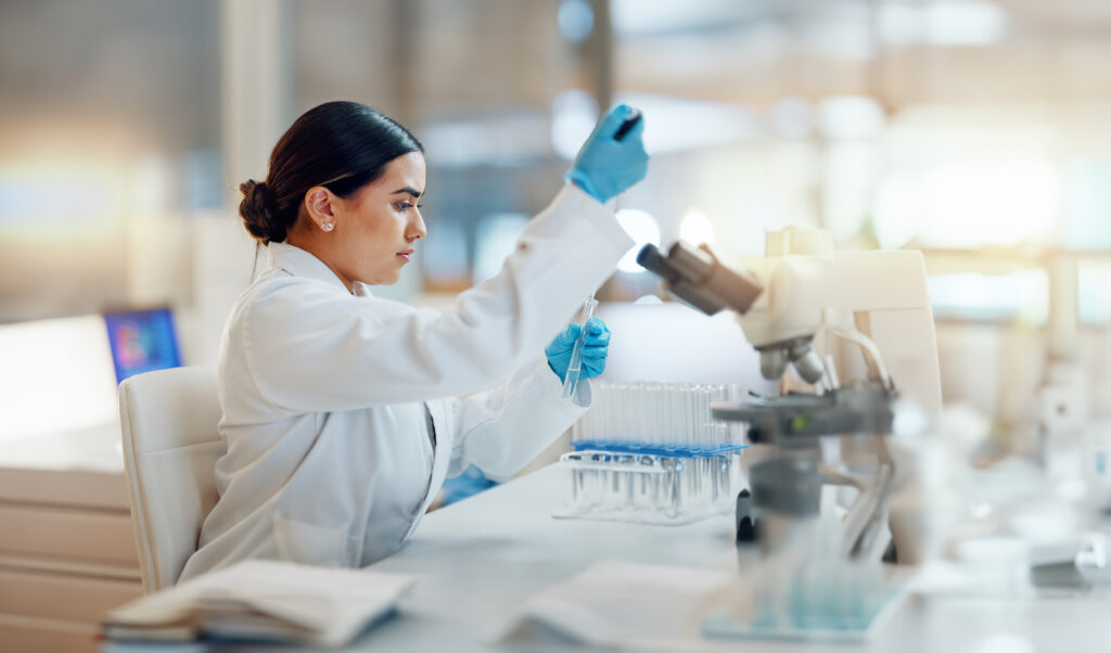 forensic scientist putting liquid into test tube