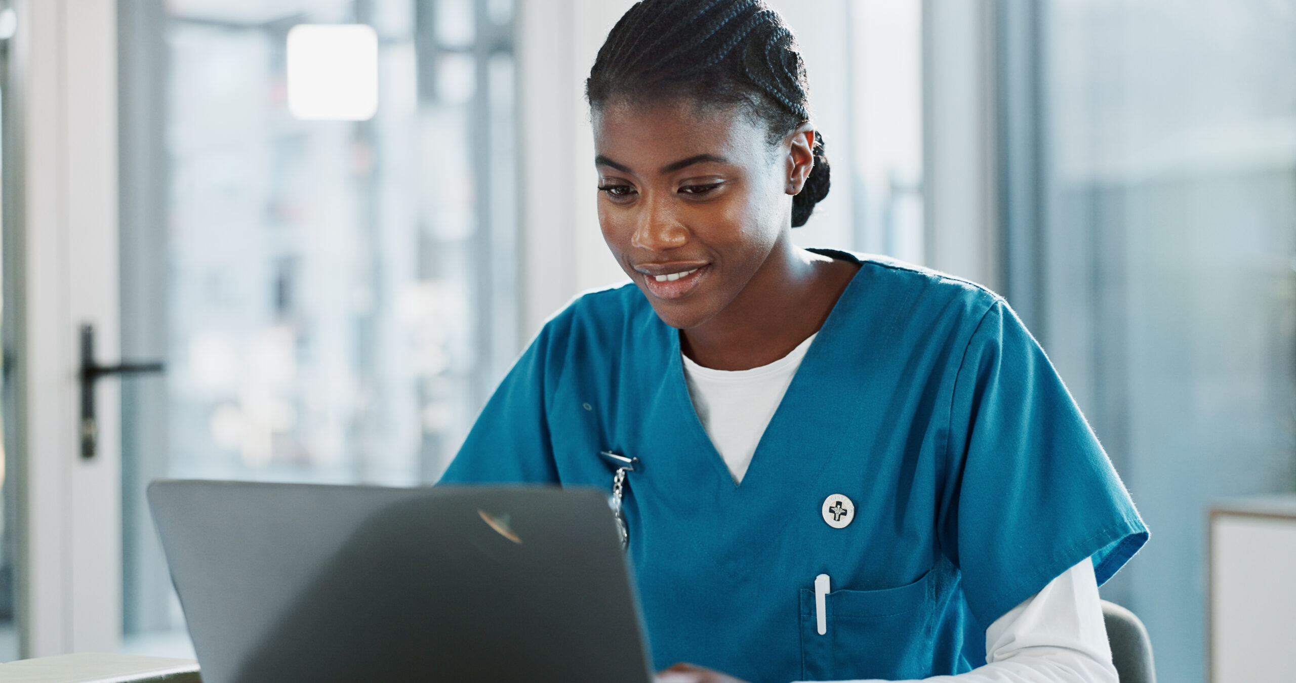 Nurse looking at a laptop