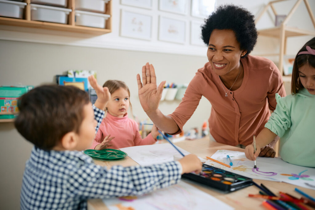 teacher high fiving student