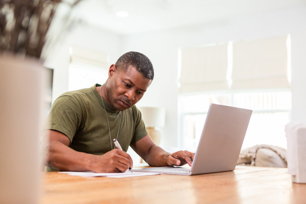 Man filling out form on laptop