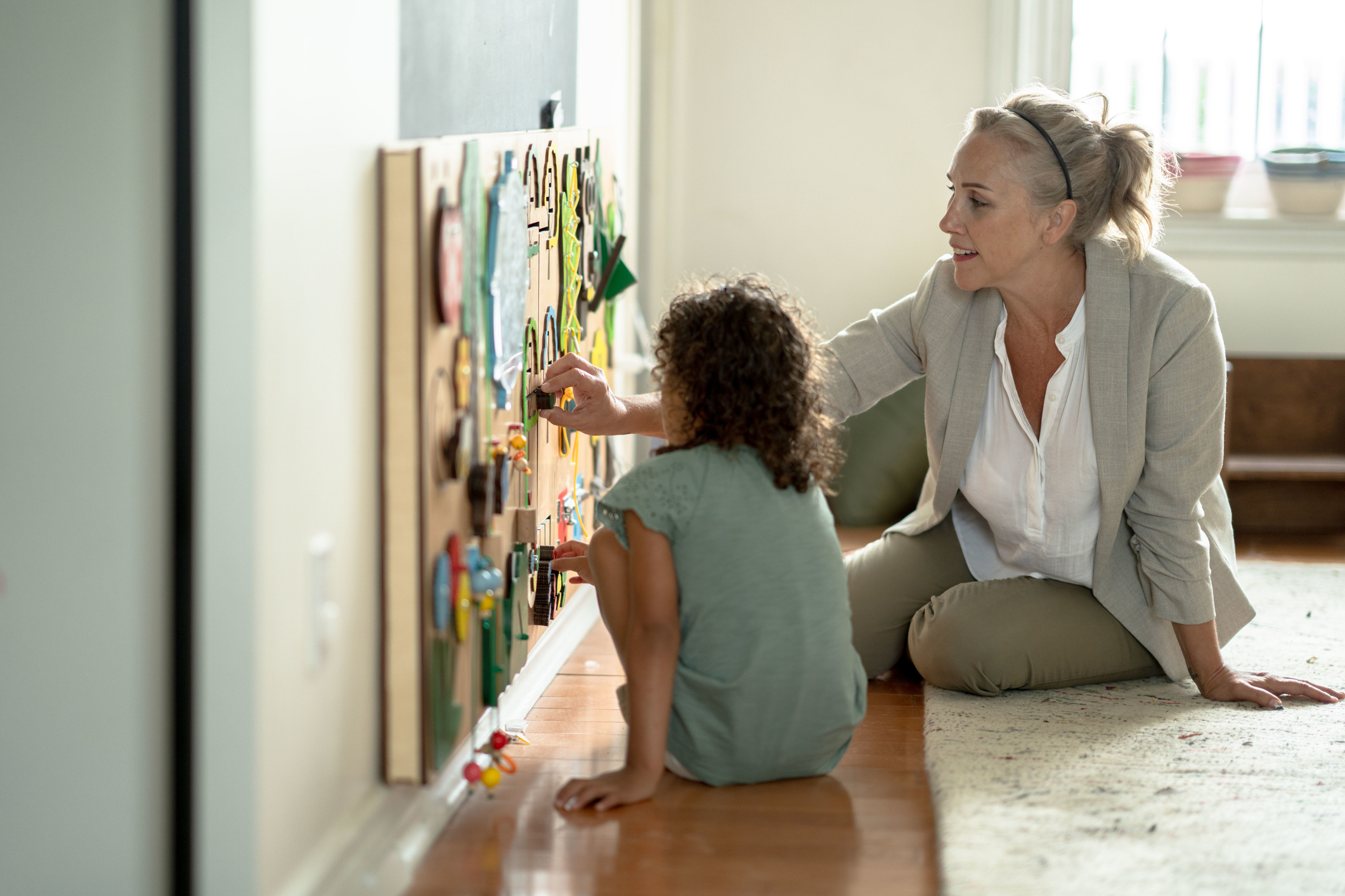 Therapist helping child with board