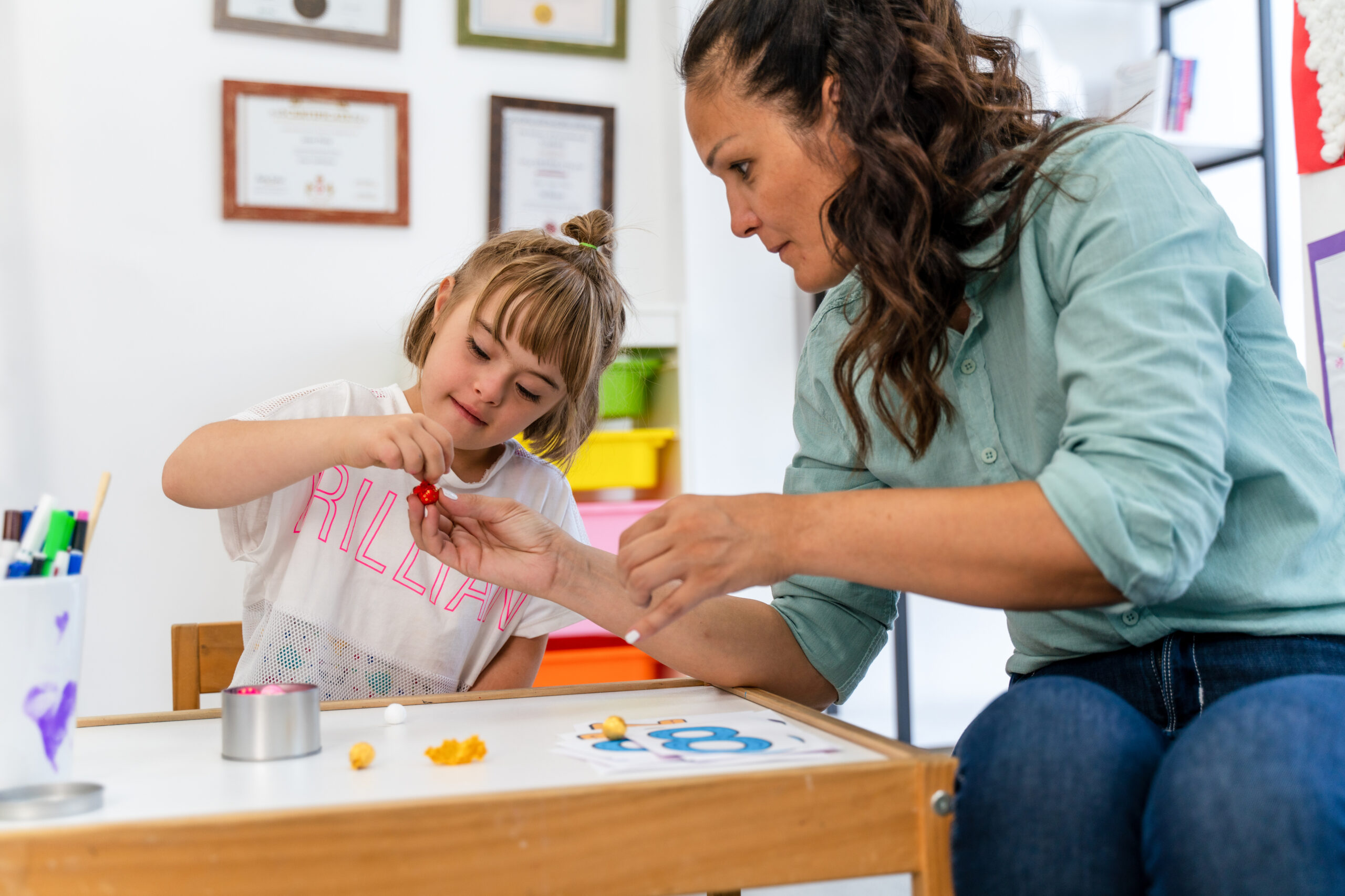 Woman helping child with play