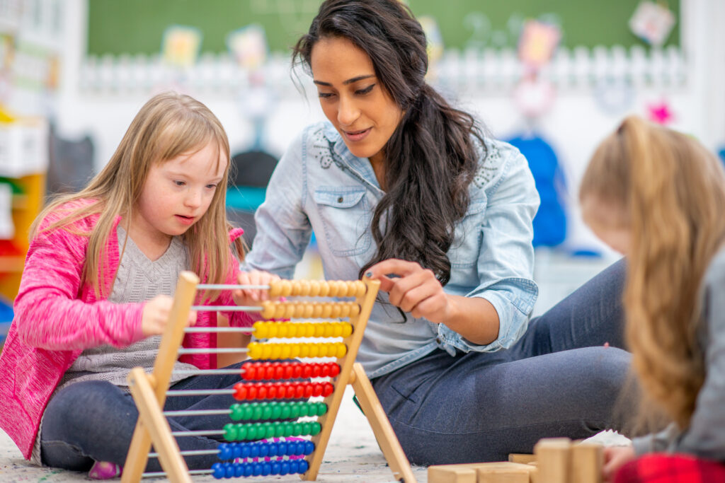 teacher teaching student with abacus
