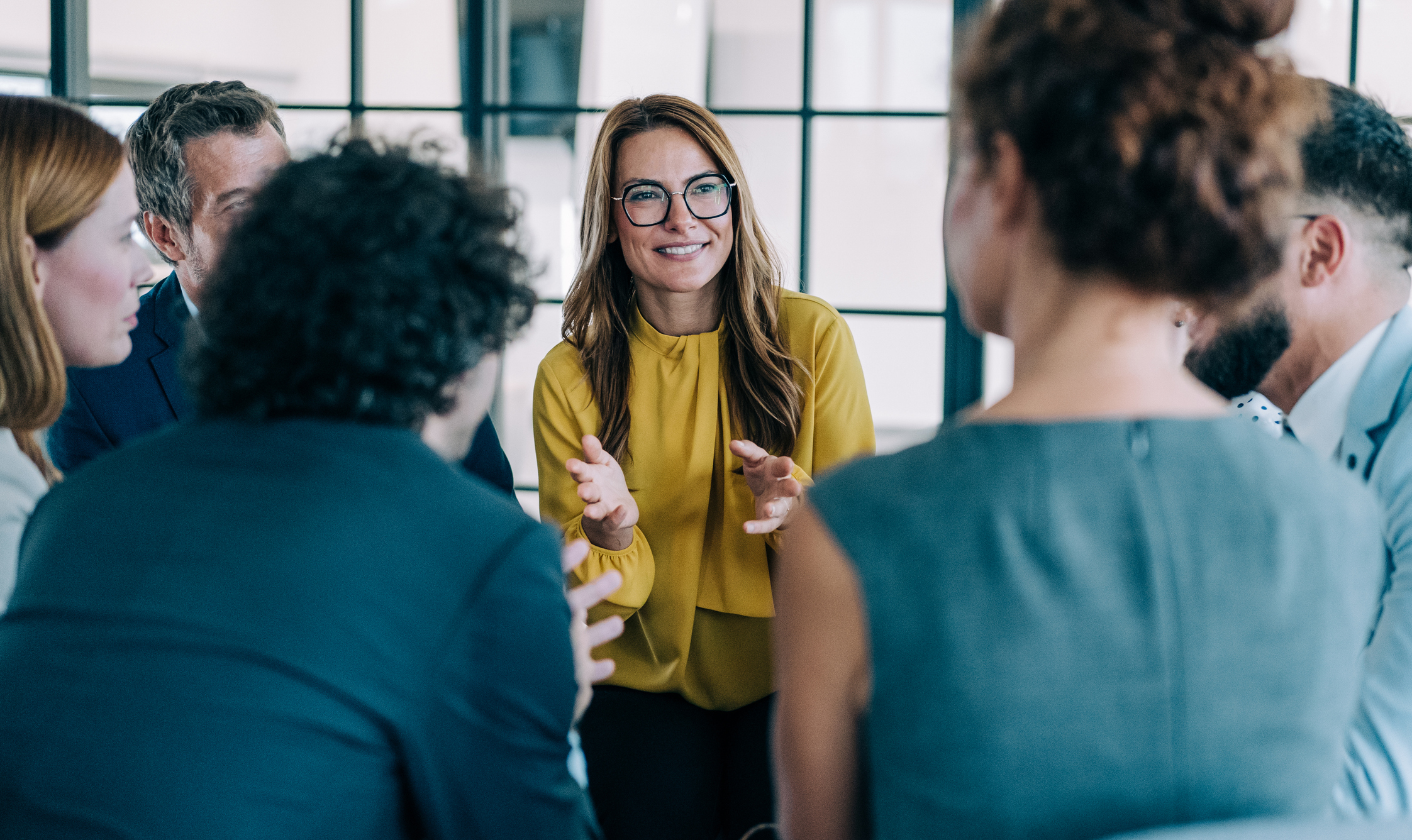 woman talking to business people