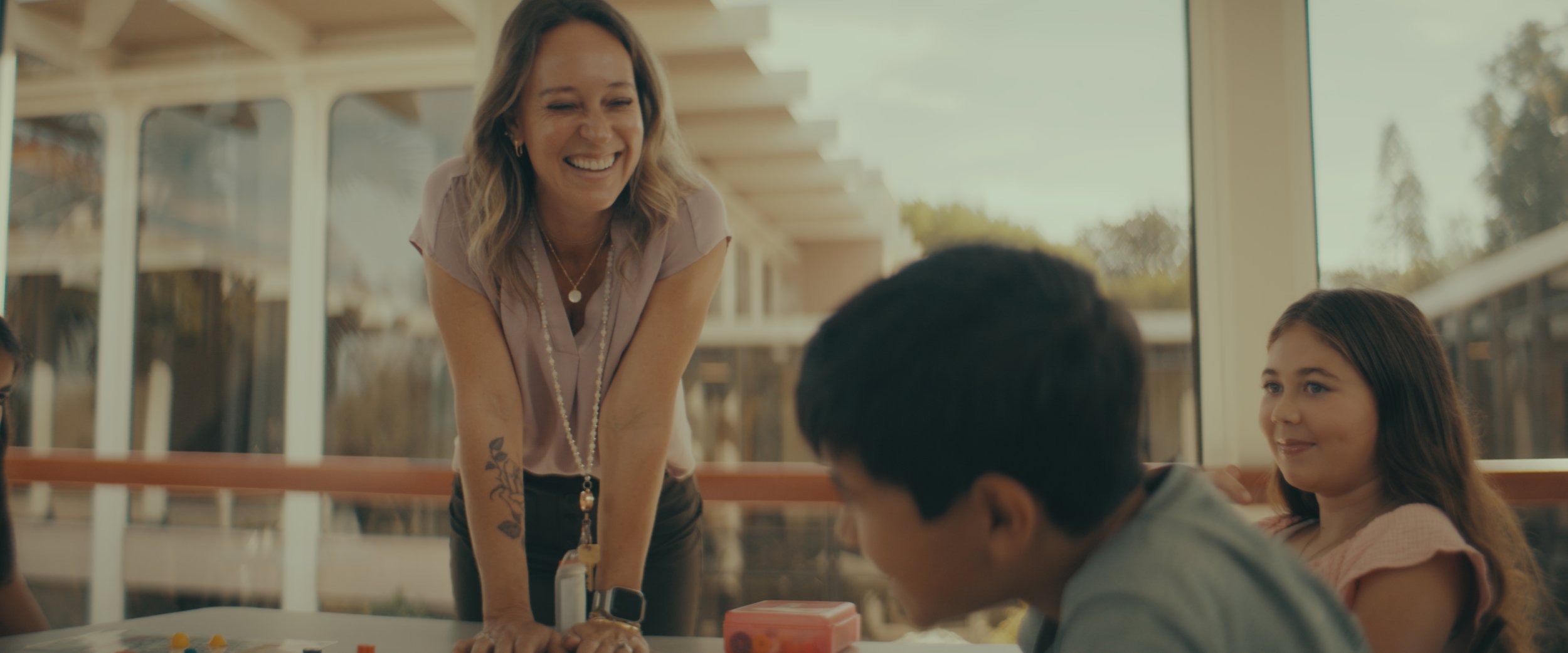 A woman smiling at a boy