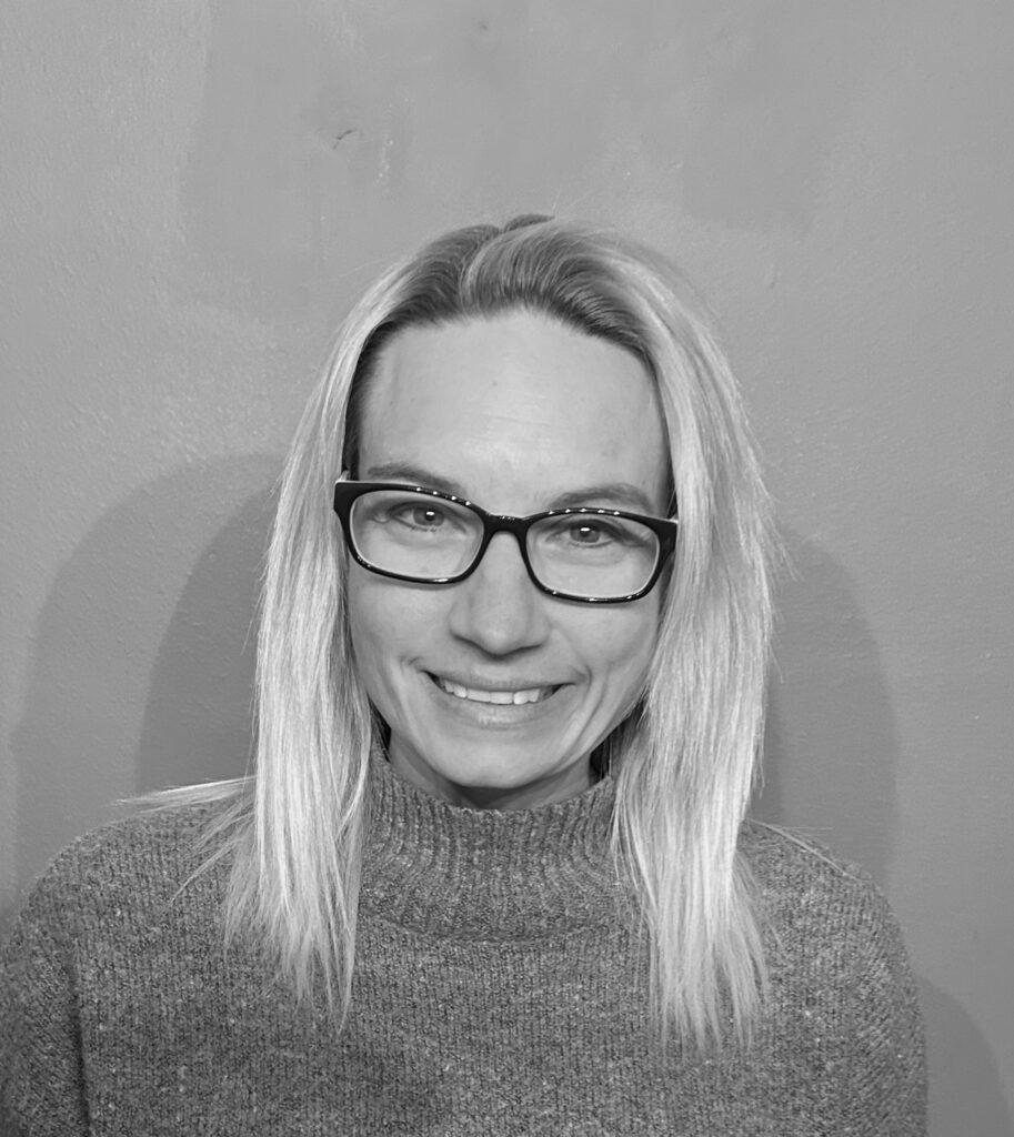 A woman wearing glasses and a sweater