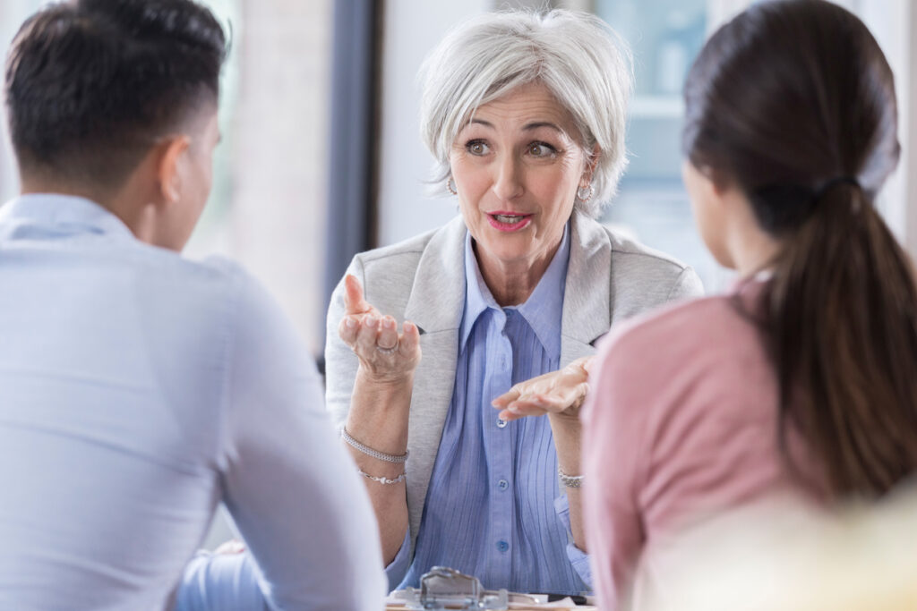A woman talking to a group of people