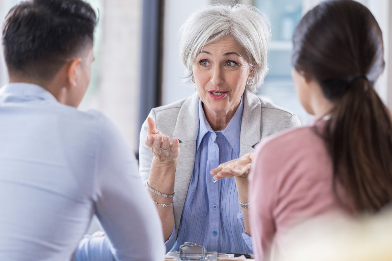 A woman talking to a group of people