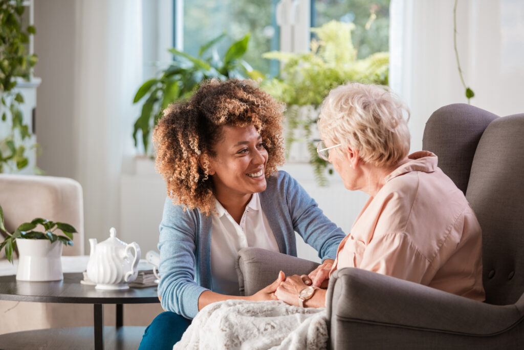 A woman and an older woman sitting in a chair