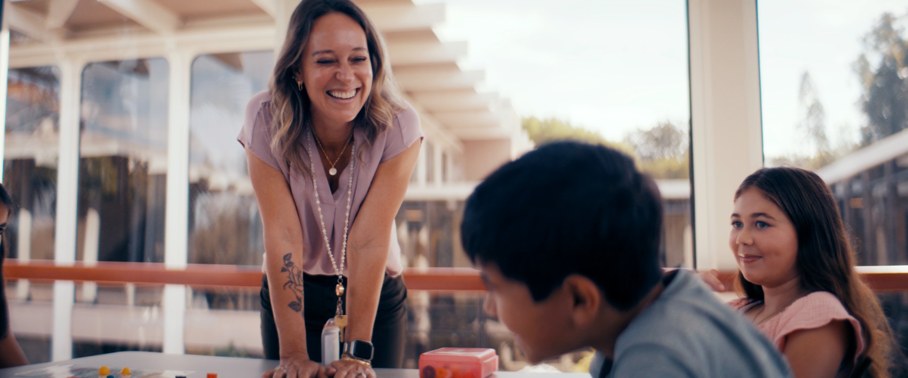 A woman smiling at a boy